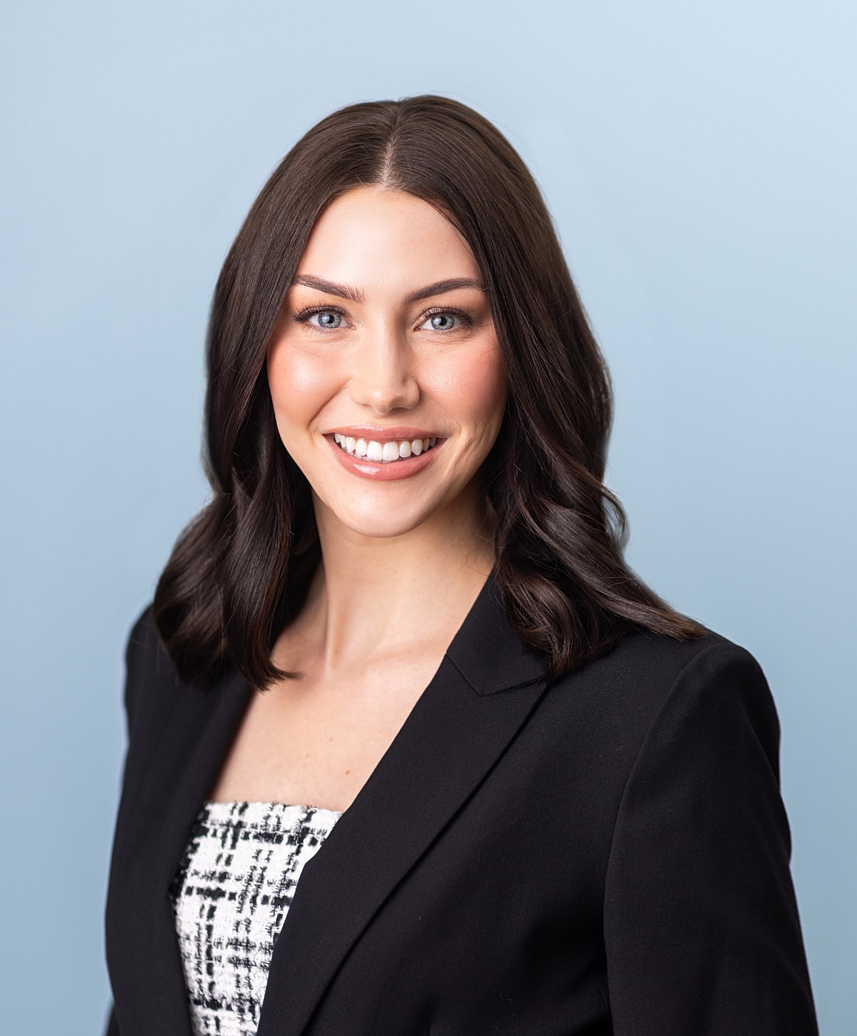 Professional headshot of a woman with dark hair.