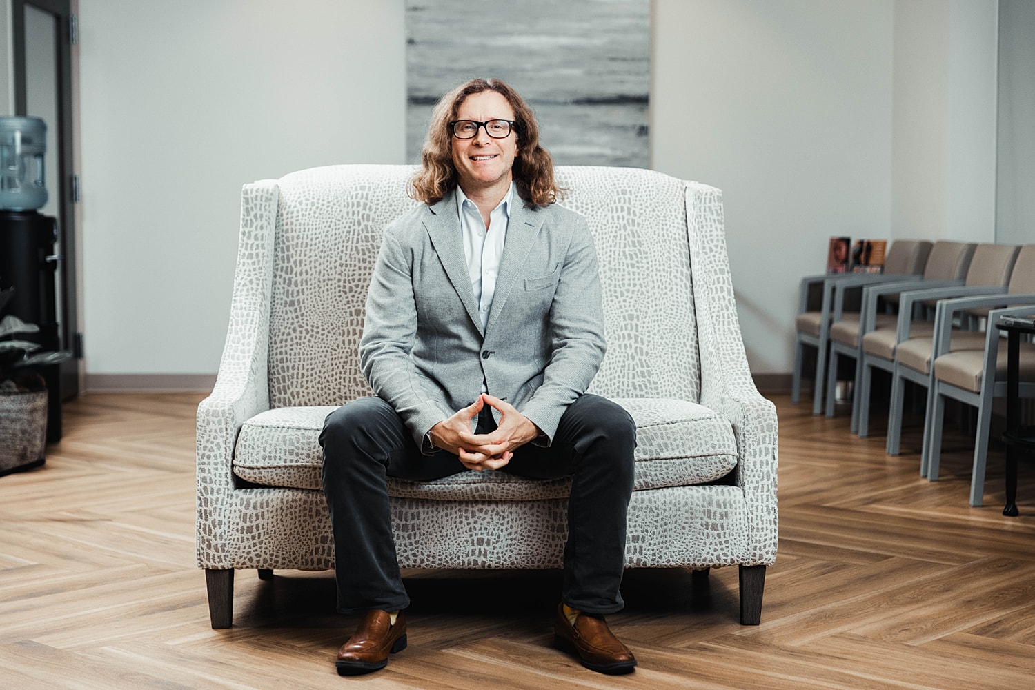Person sitting on a couch in an office.