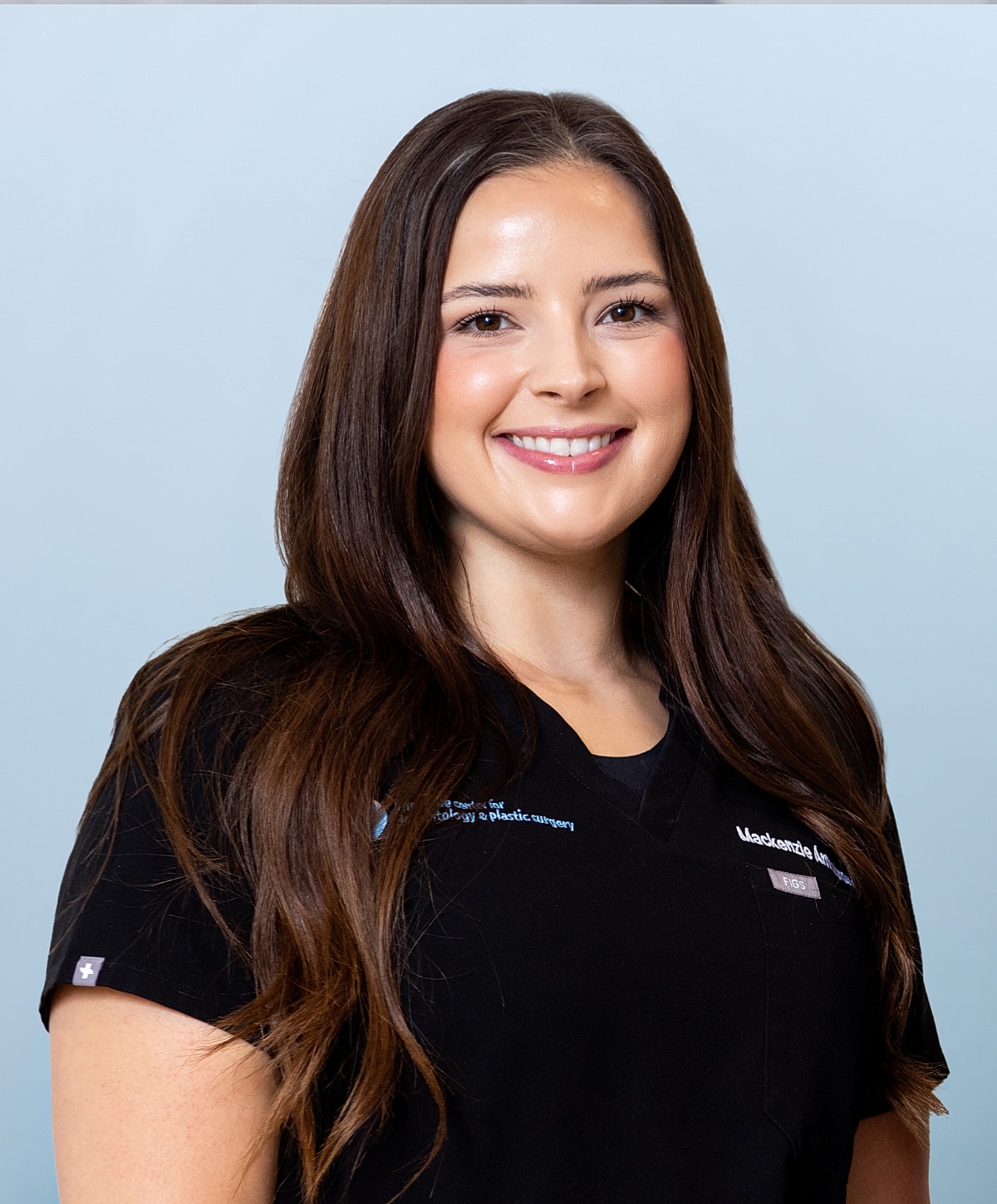 Smiling woman with long brown hair in black shirt.