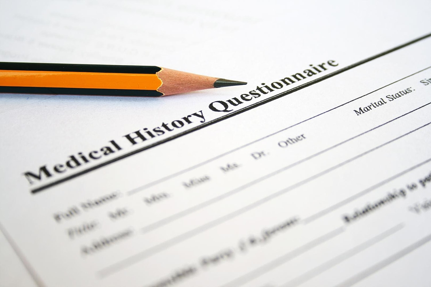 Medical history questionnaire with pencil on paper.