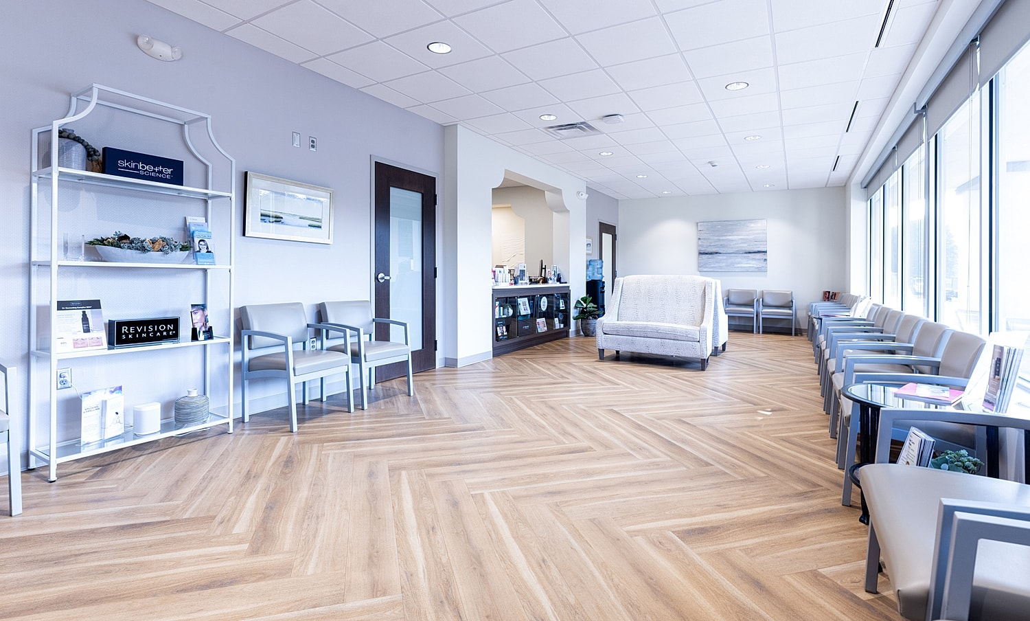 Modern waiting room with wooden floor and decor.