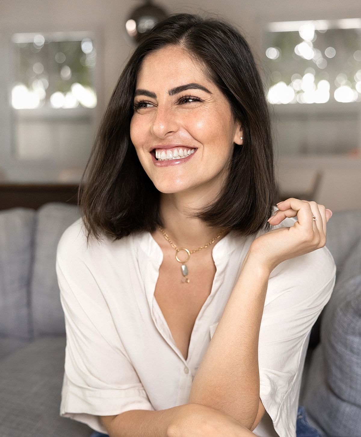 Smiling woman with short hair in casual setting.