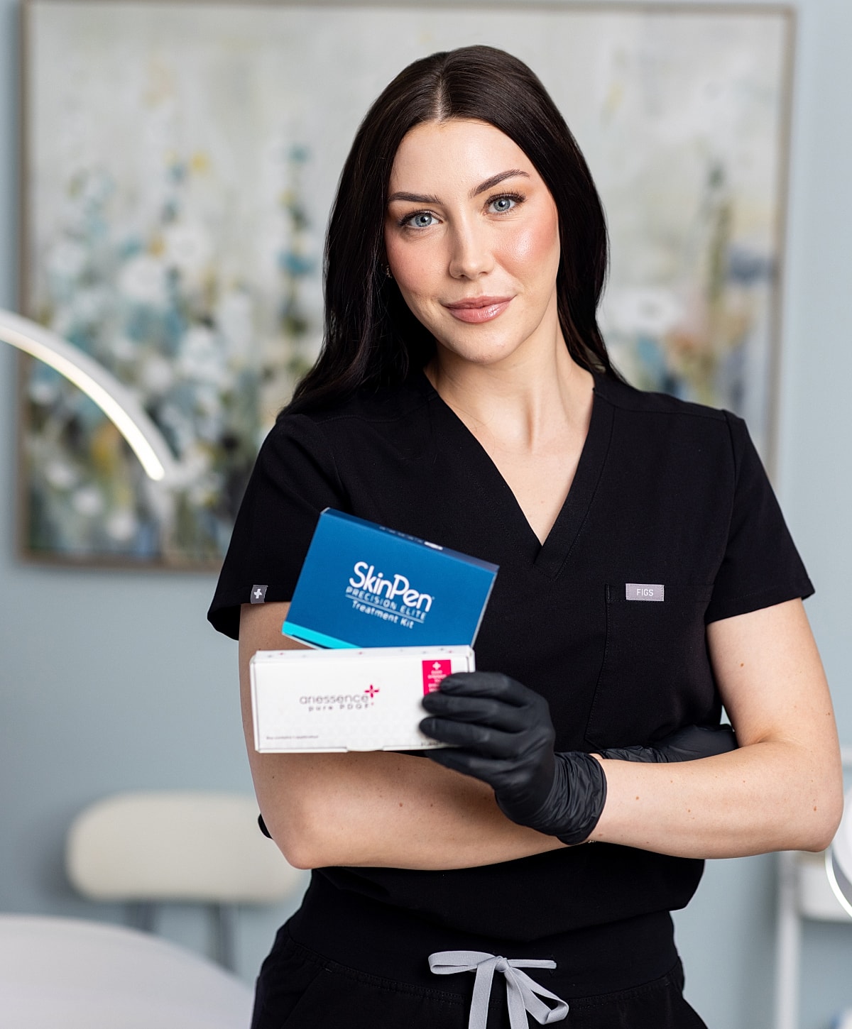 Professional holding skincare products in clinic setting