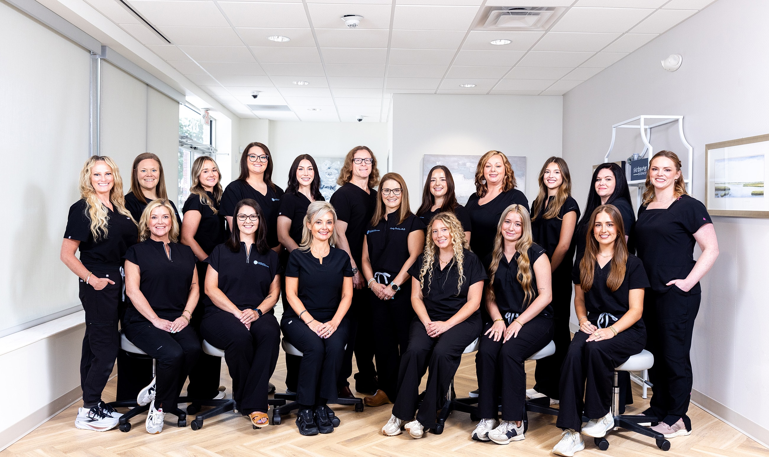 Team of professionals in black scrubs posing together