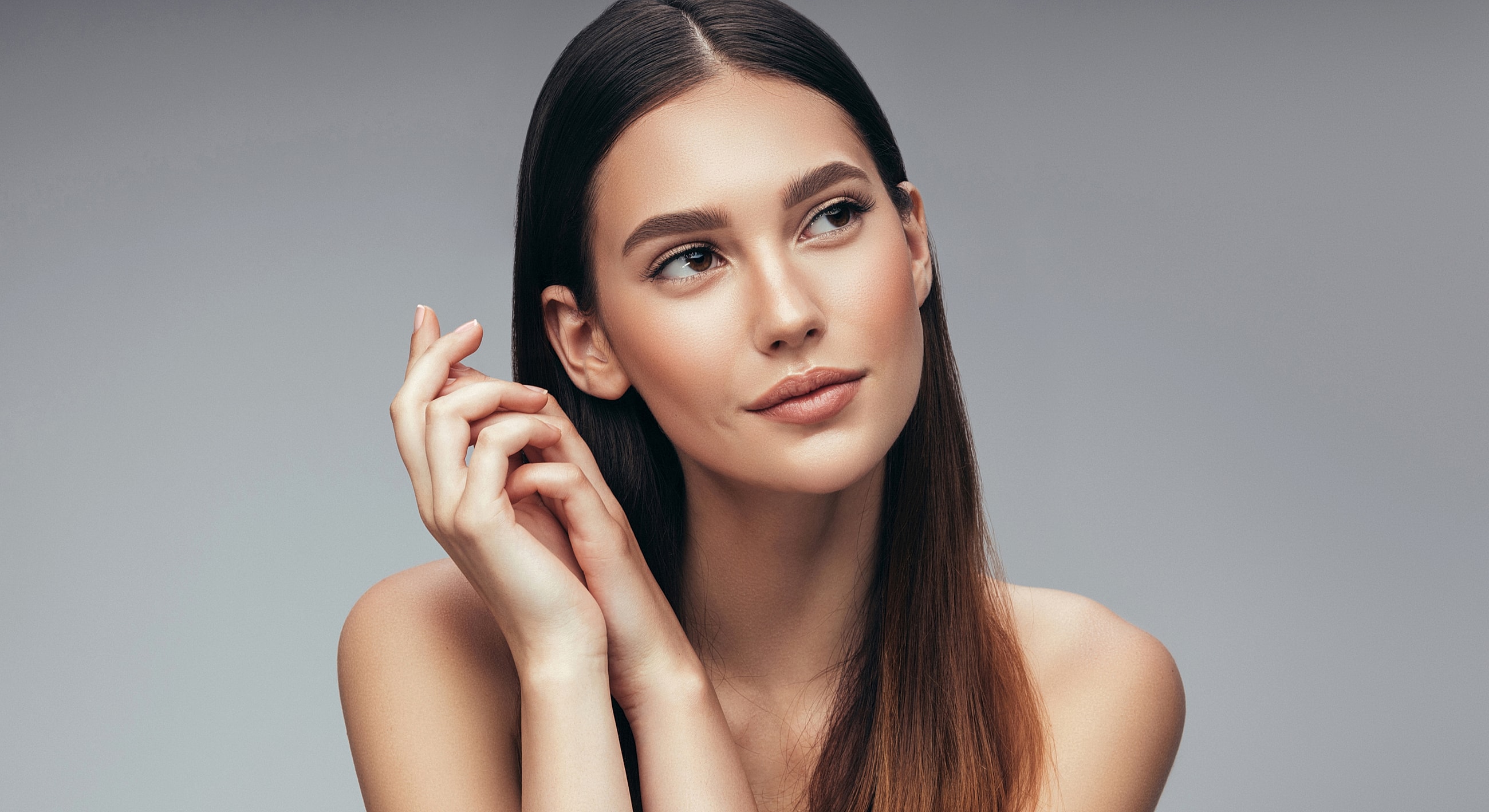 Young woman with long hair and thoughtful expression